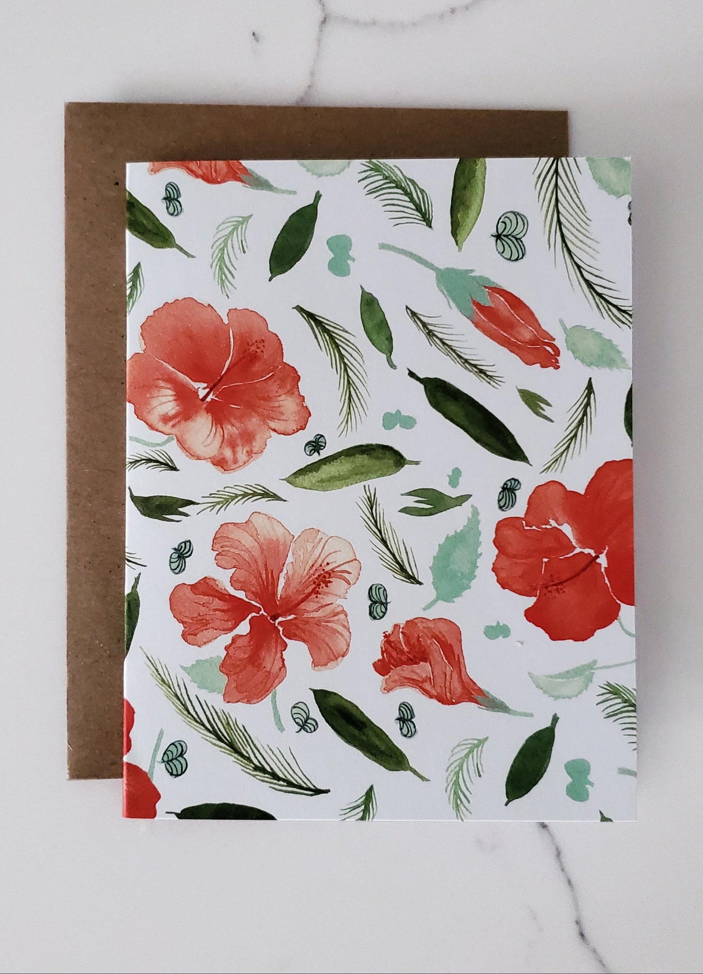 Floral patterned card with red flowers and green leaves on a white background