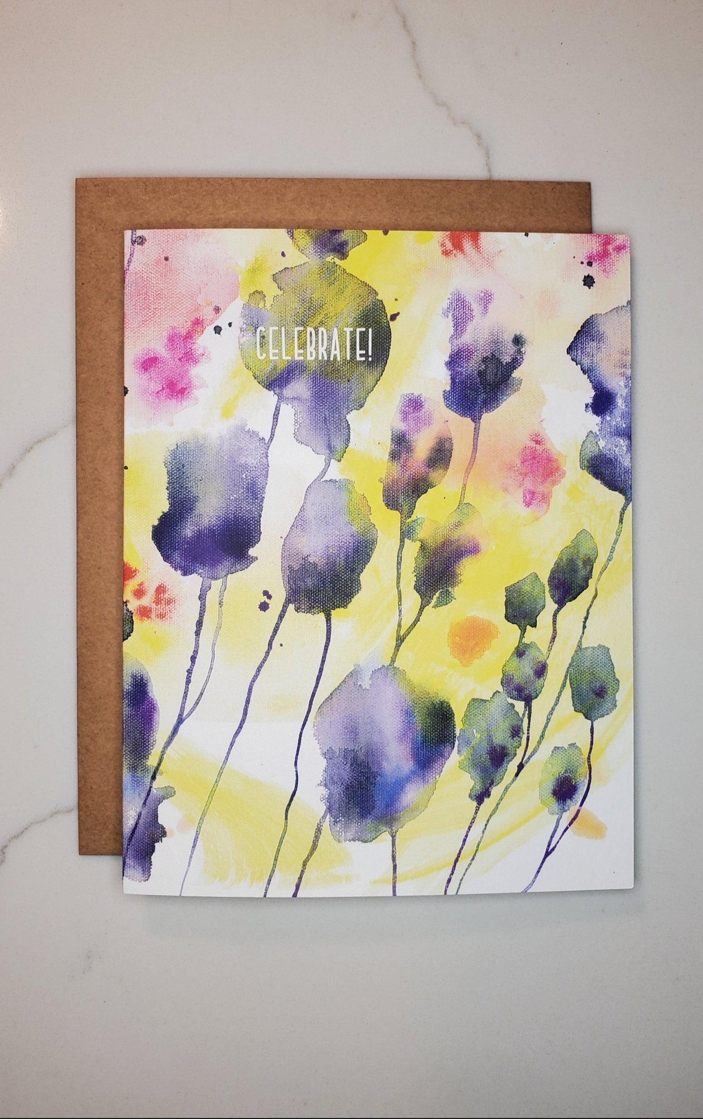 Greeting card with watercolor floral design on a white surface