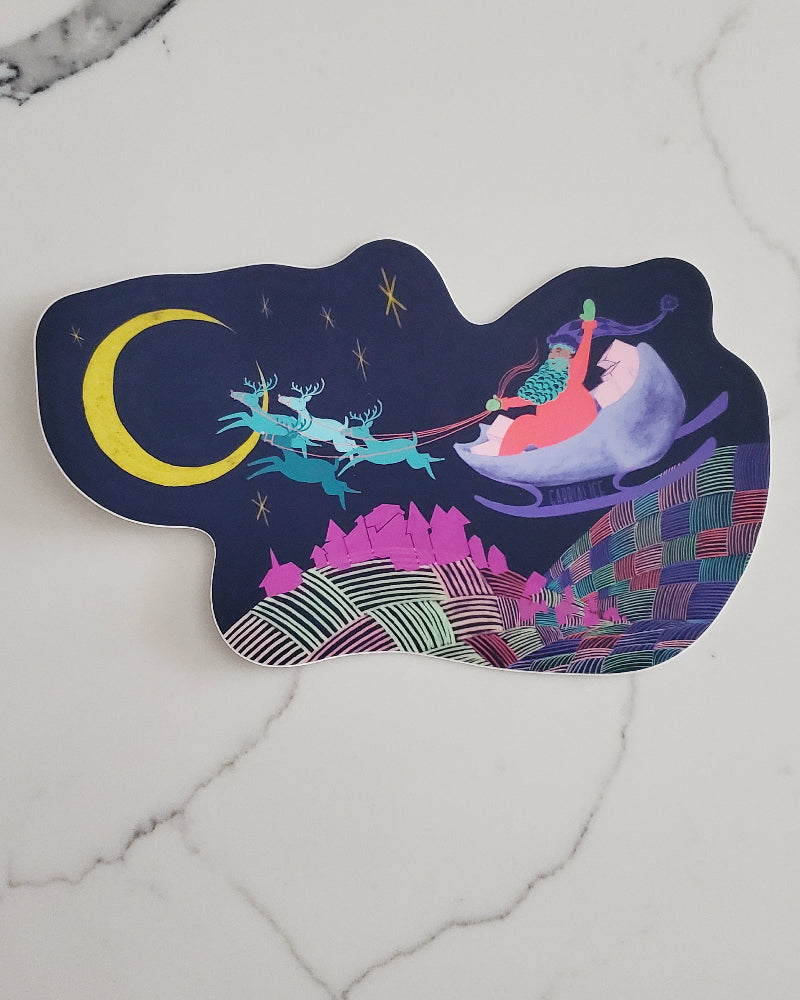 vinyl die cut santa christmas holiday sticker village below reindeer pulling sleigh flying through sky on the way to a sliver yellow moon hills below are multicolored and textured like a fluffy patchwork quilt santa waving