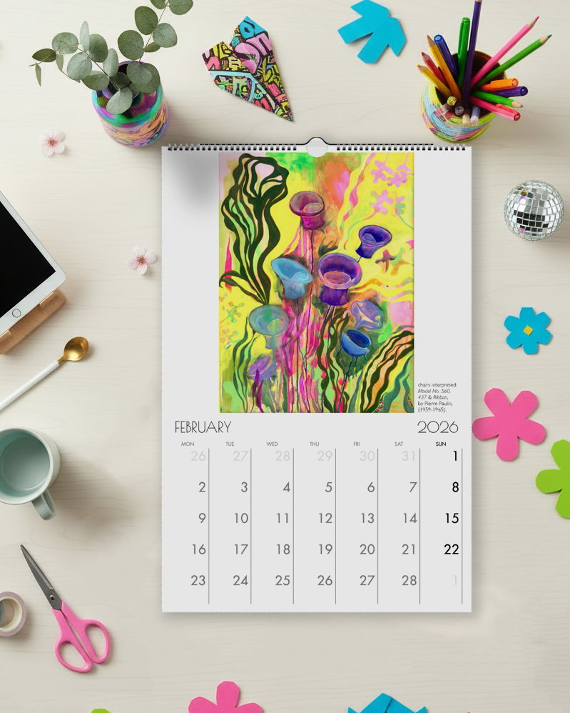 Calendar for February 2026 on a desk with stationery items and decorative flowers.