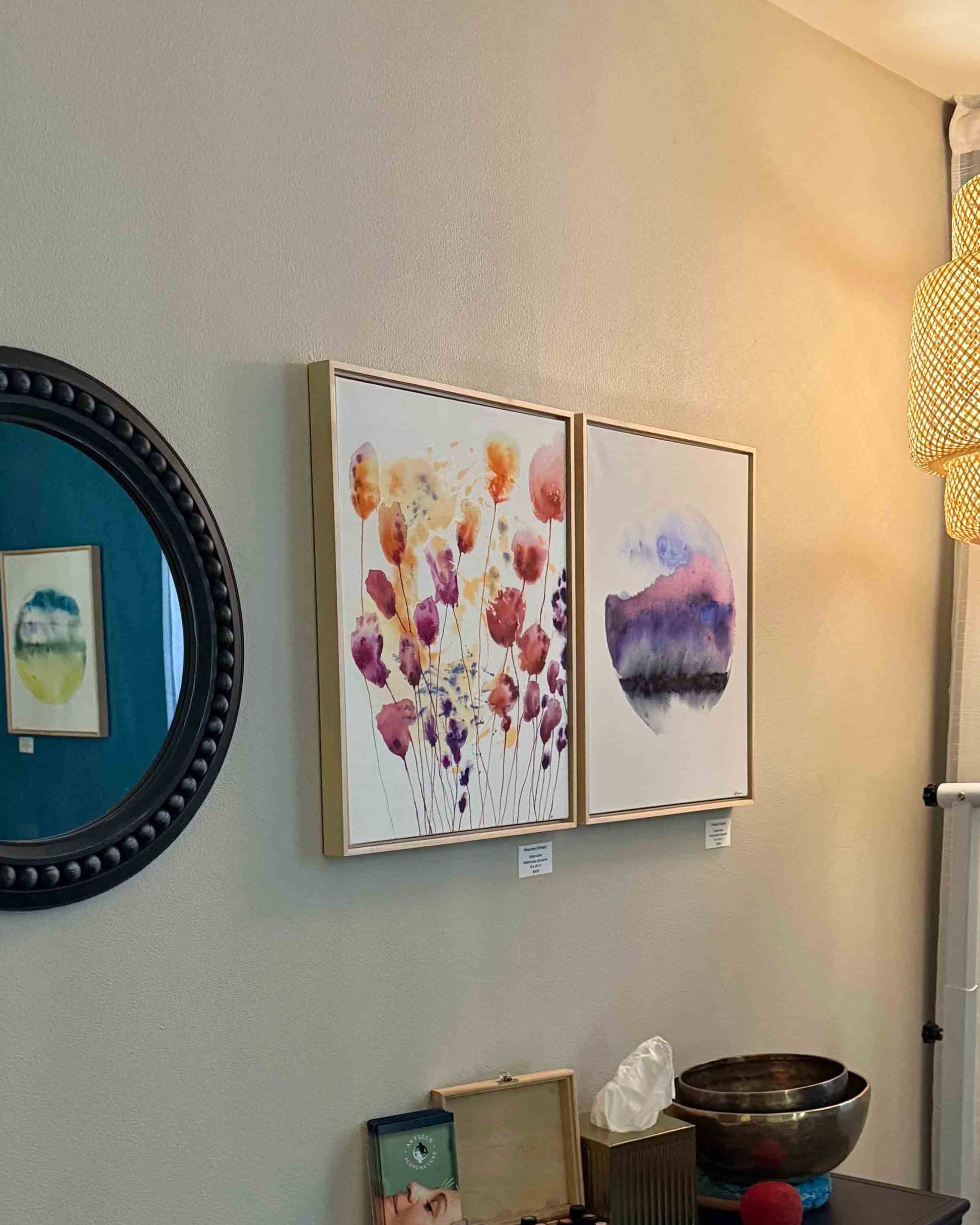 Room interior with framed artwork, decorative items on a dresser, and a hanging light fixture. maple wood float Framed abstract watercolor painting on canvas with a gradient of blue, pink, and purple on a white background. Fantasy planet, mysterious dark but flowing whimsical