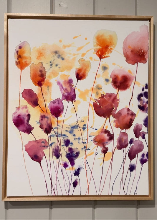 Framed artwork of colorful floral design on a plain wall