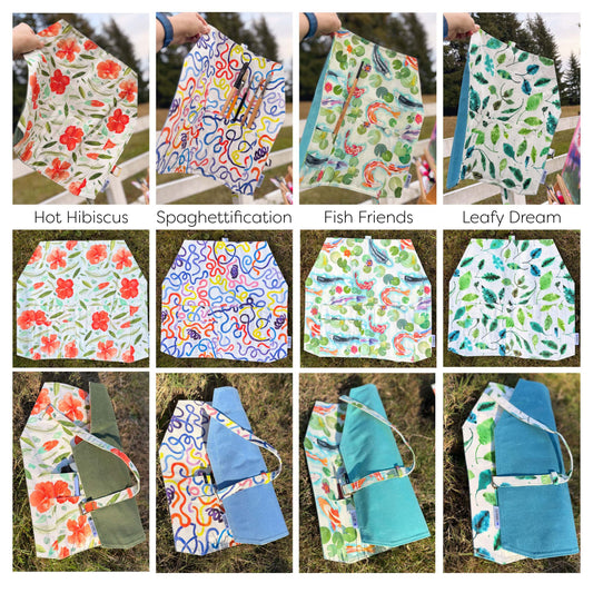 A collage showing four different canvas paint brush rolls laid out outdoors on grass, each with a unique colorful abstract or floral print. Some panels show the items being held up by a person's hand, and each image has a text label underneath Hot Hibiscus, Spaghettification, Fish Friends, Leafy Dream.