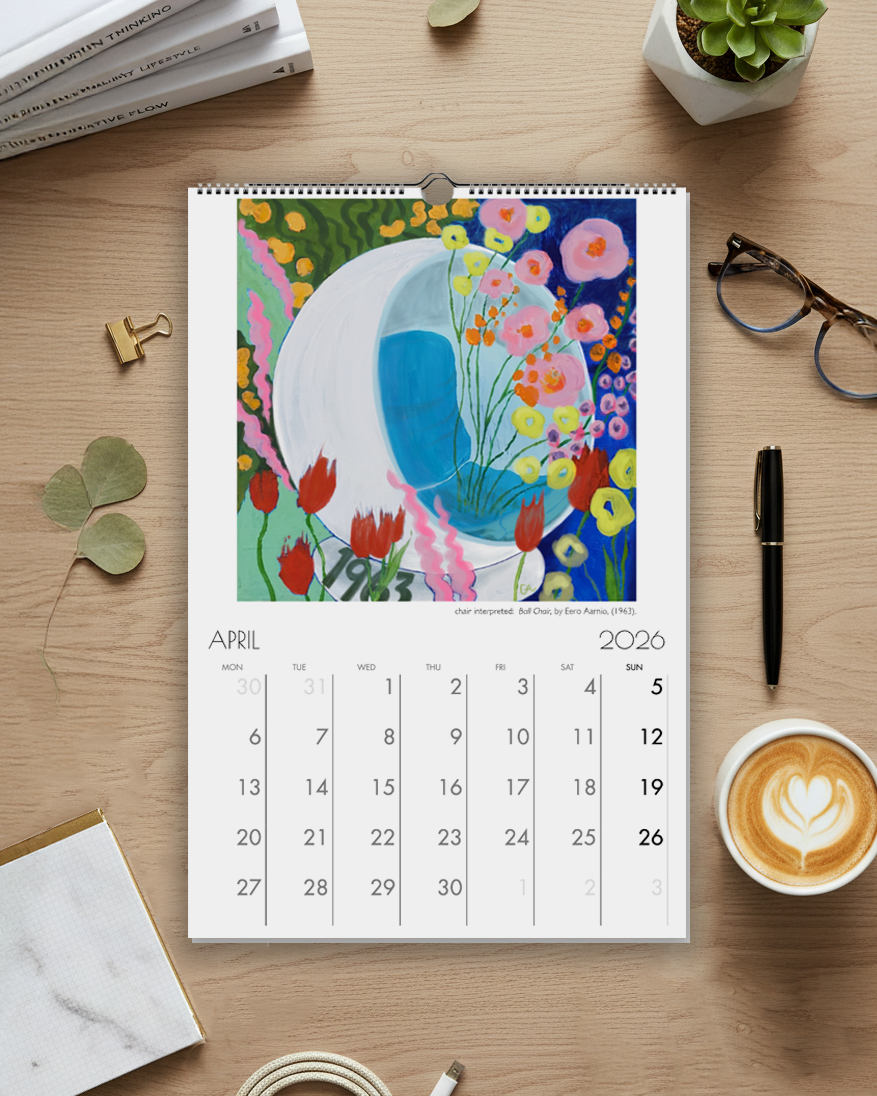 Calendar on a wooden desk with a cup of coffee, glasses, and office supplies.