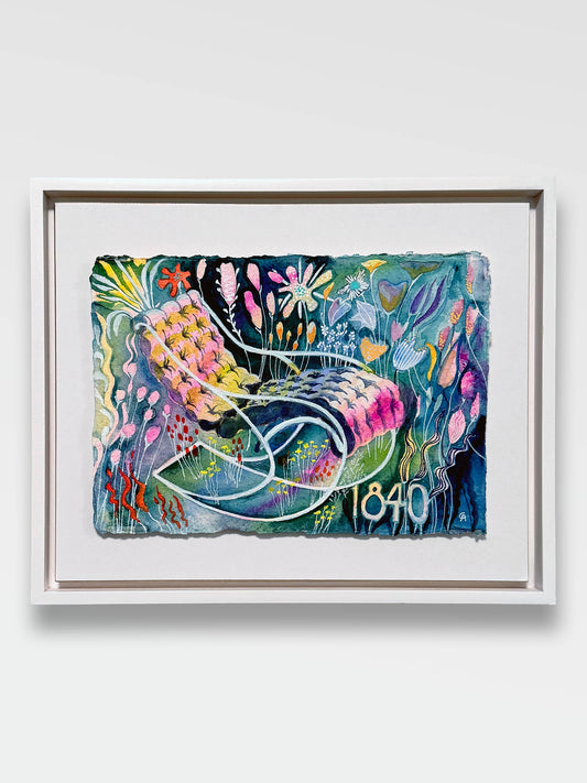 Framed artwork in a white frame with a white mat float board, with colorful abstract design on a white wall. lots of color watercolor on a recycled cotton cold press textured paper with raw ripped edge. florals surround a lounge tufted chair with curvy classic lines from 1840