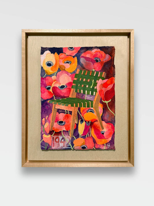 Framed artwork of a colorful chair surrounded by flowers on a neutral grey wall. maple frame with a float board and watercolor art piece floating with a shadow gap on the board. bright red and pink anemone flowers with yellow and purple accents surround a green lattice chair designed in 1942 in scandinavia. modern design with a lush surround of blooms. tiny pistons are visible in the centers of several of the anemones.