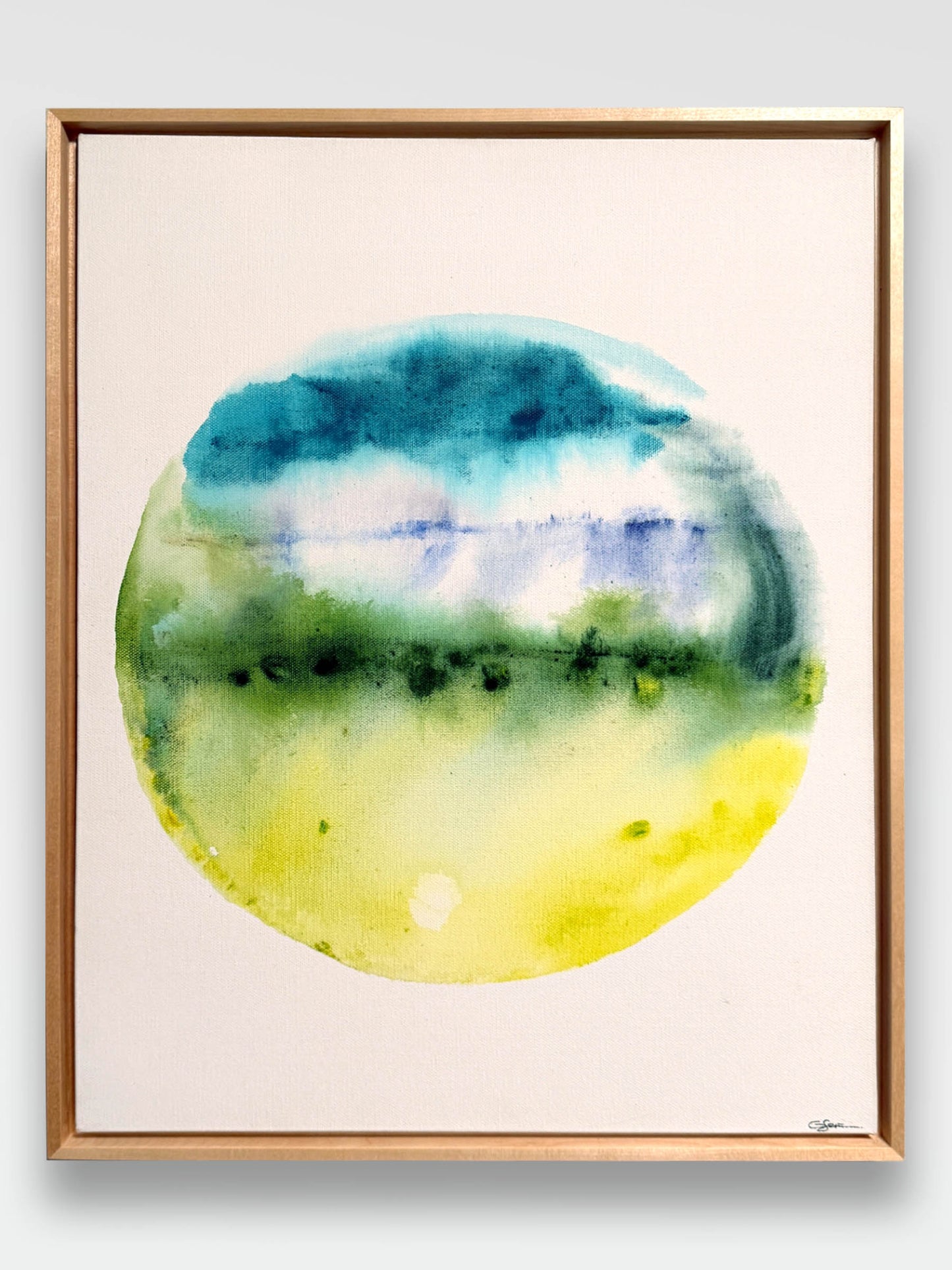 Framed watercolor painting on canvas with circular design in blue, green, and yellow green hues on a white background. 